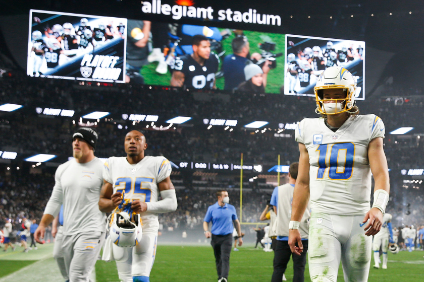 Justin Herbert #10 of the Los Angeles Chargers walks offsides the field after being defeated by the Las Vegas Raiders at Allegiant Stadium