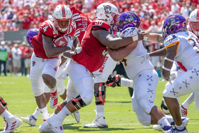 North Carolina State Wolfpack running back Zonovan Knight (24) runs through the hole for his first collegiate touchdown during the game between the ECU Pirates and the NC State Wolfpack