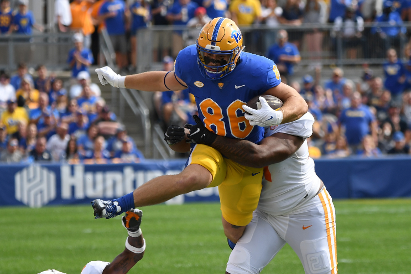 Gavin Bartholomew #86 of the Pittsburgh Panthers attempts to jump over Jaylen McCollough #2 of the Tennessee Volunteers after making a catch 