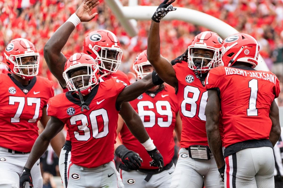 Dillon Bell #86 celebrates his touchdown with Marcus Rosemy-Jacksaint #1 and Daijun Edwards #30 of the Georgia Bulldogs during a game between Samford Bulldogs and Georgia Bulldogs