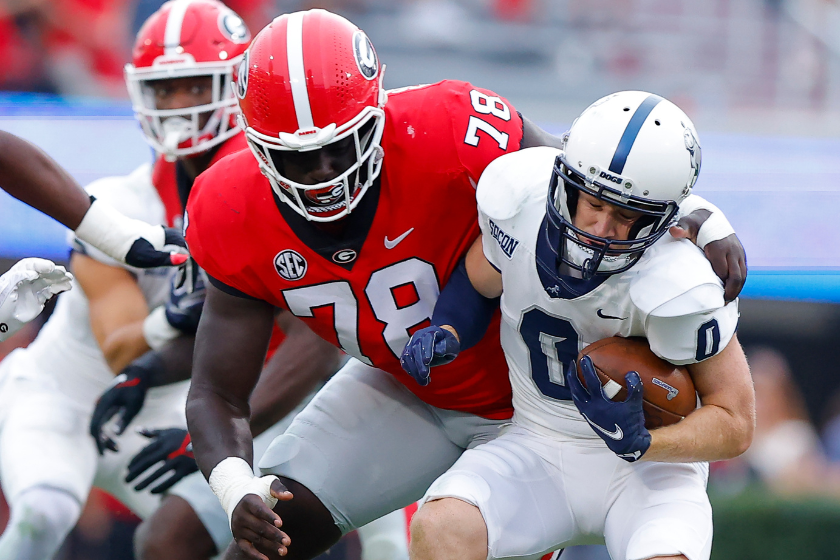 Chandler Smith #0 of the Samford Bulldogs is wrapped up by Nazir Stackhouse #78 of the Georgia Bulldogs