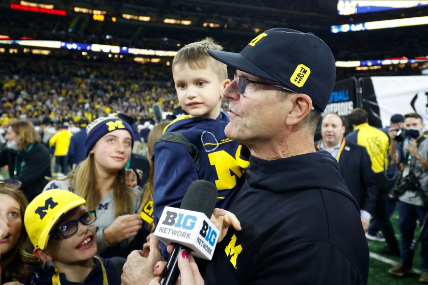 Jim Harbaugh with his son after a game.