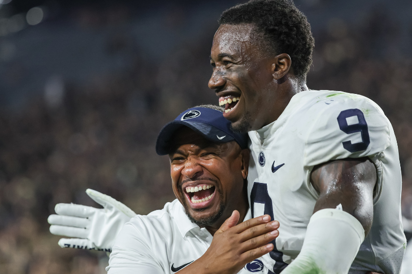Joey Porter Jr. #9 of the Penn State Nittany Lions celebrates with a coaching staff member following the game against the Purdue Boilermakers