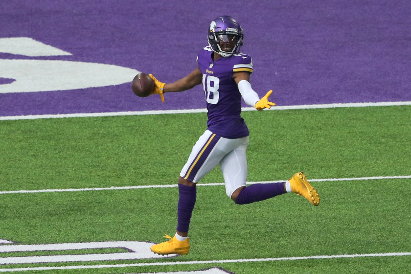 Justin Jefferson #18 of the Minnesota Vikings scores a touchdown against the Tennessee Titans
