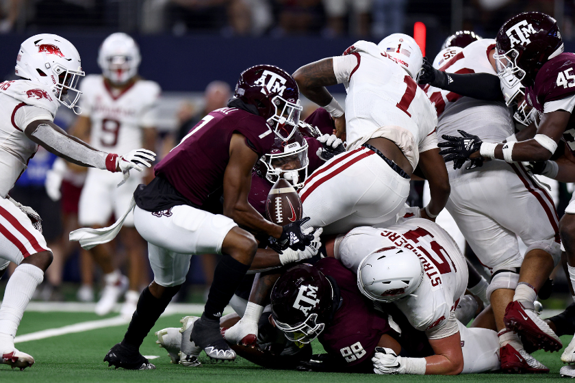 Defensive back Tyreek Chappell #7 of the Texas A&M Aggies recovers a fumble for a touchdown against quarterback KJ Jefferson #1 of the Arkansas Razorbacks