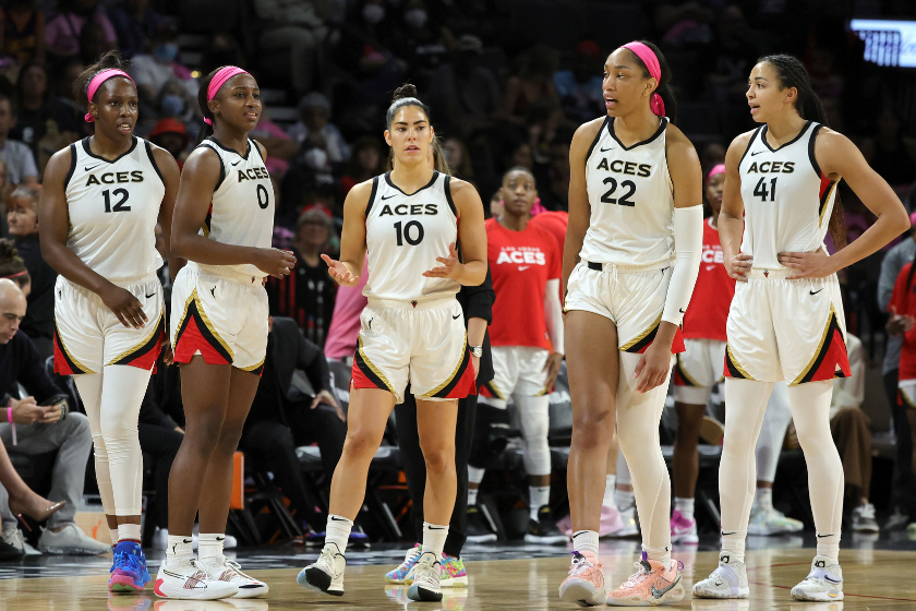 Chelsea Gray #12, Jackie Young #0, Kelsey Plum #10, A'ja Wilson #22 and Kiah Stokes #41 of the Las Vegas Aces walk back on the court after a timeout