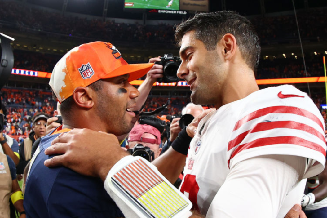 Russell Wilson #3 of the Denver Broncos and Jimmy Garoppolo #10 of the San Francisco 49ers shake hands at Empower Field At Mile High