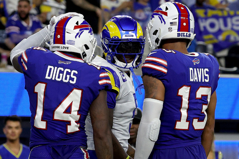 Stefon Diggs #14 and Gabe Davis #13 of the Buffalo Bills speak to Jalen Ramsey #5 of the Los Angeles Rams after a Diggs touchdown, to take a 31-10 lea