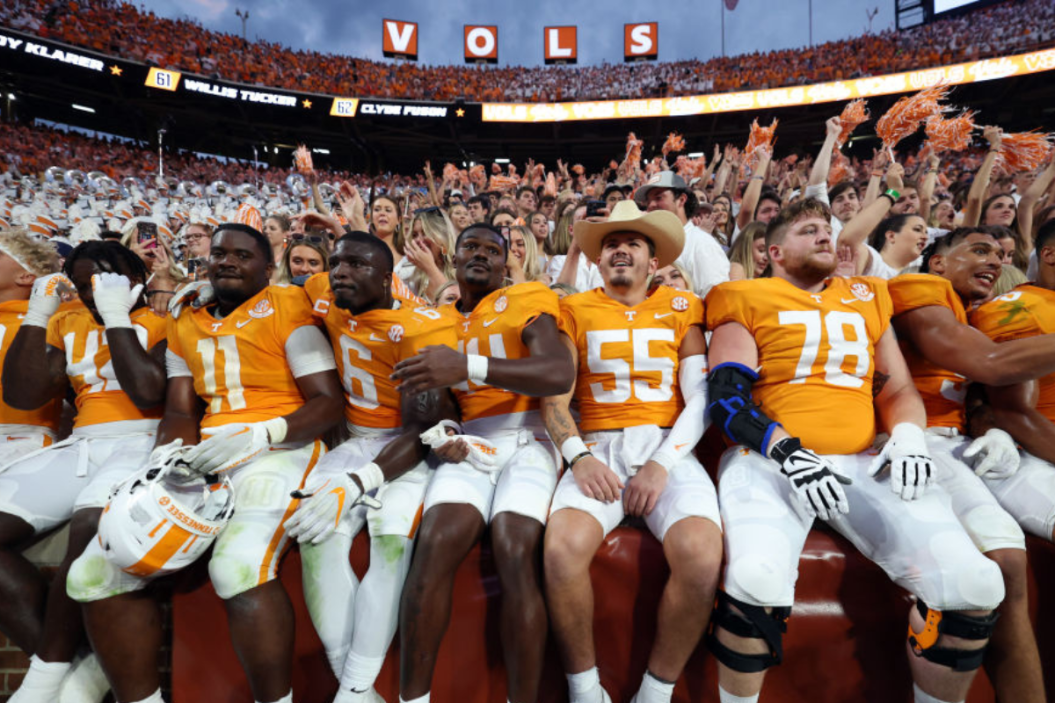 The Tennessee Volunteers team celebrates in the stands with the fans after a win against the Florida Gators