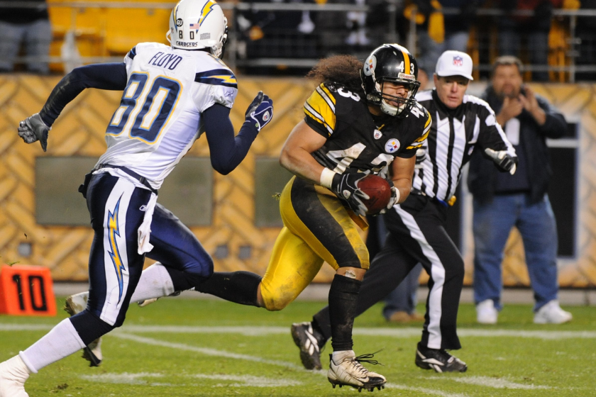 Safety Troy Polamalu #43 of the Pittsburgh Steelers runs to the end zone with a fumble recovery as he is chased by wide receiver Malcom Floyd #80 and as referee Scott Green watches during the final seconds of a game 