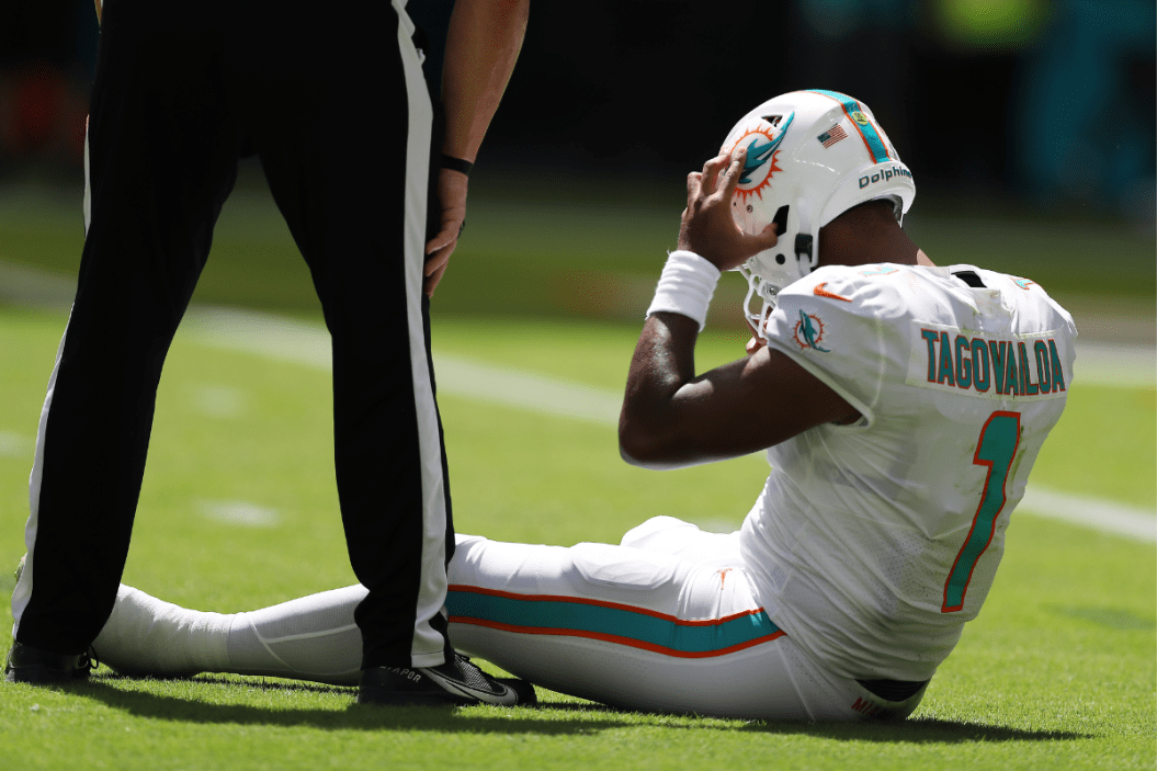 Quarterback Tua Tagovailoa #1 of the Miami Dolphins sits on the turf during the first half of the game against the Buffalo Bills
