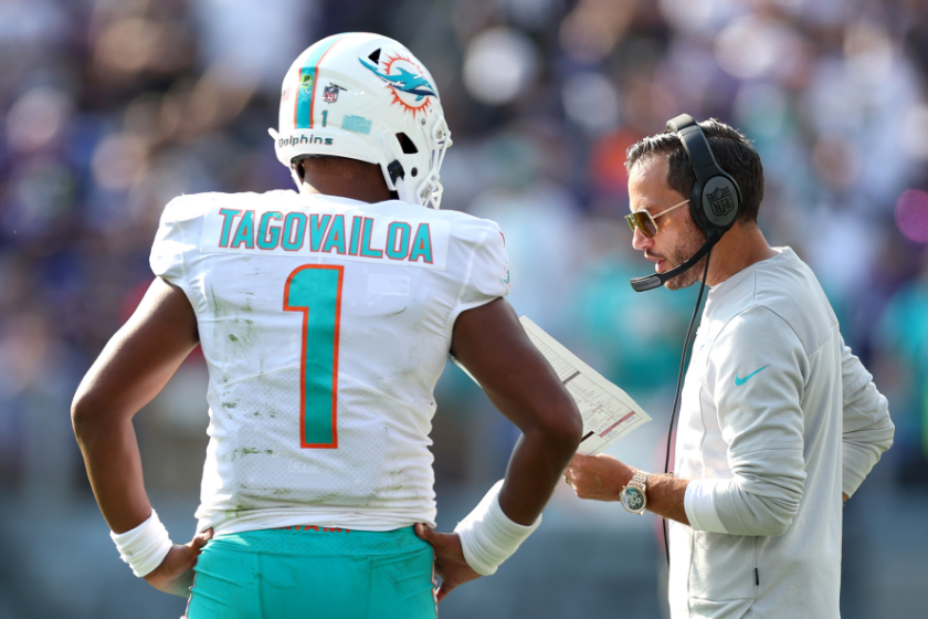 Head coach Mike McDaniel of the Miami Dolphins talks with quarterback Tua Tagovailoa #1 of the Miami Dolphins in the second half against the Baltimore Ravens