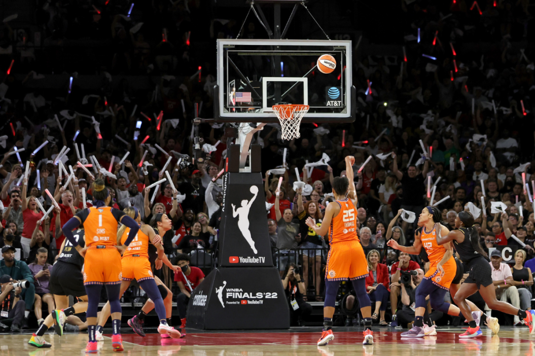 Fans wave glow batons as Alyssa Thomas #25 of the Connecticut Sun shoots a free throw against the Las Vegas Aces in the third quarter of Game One of the 2022 WNBA Playoffs finals