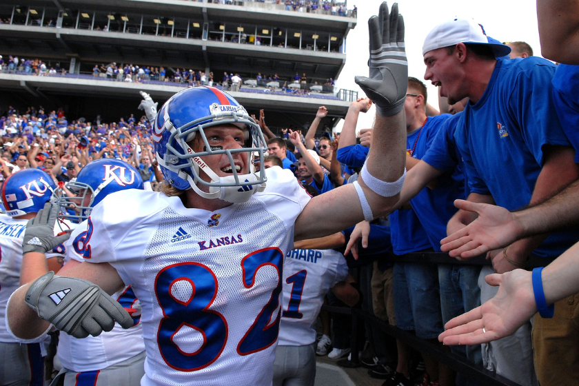 Jeff Foster #82 of the Kansas Jayhawks celebrates with Jayhawk fans after beating the Kansas State Wildcats