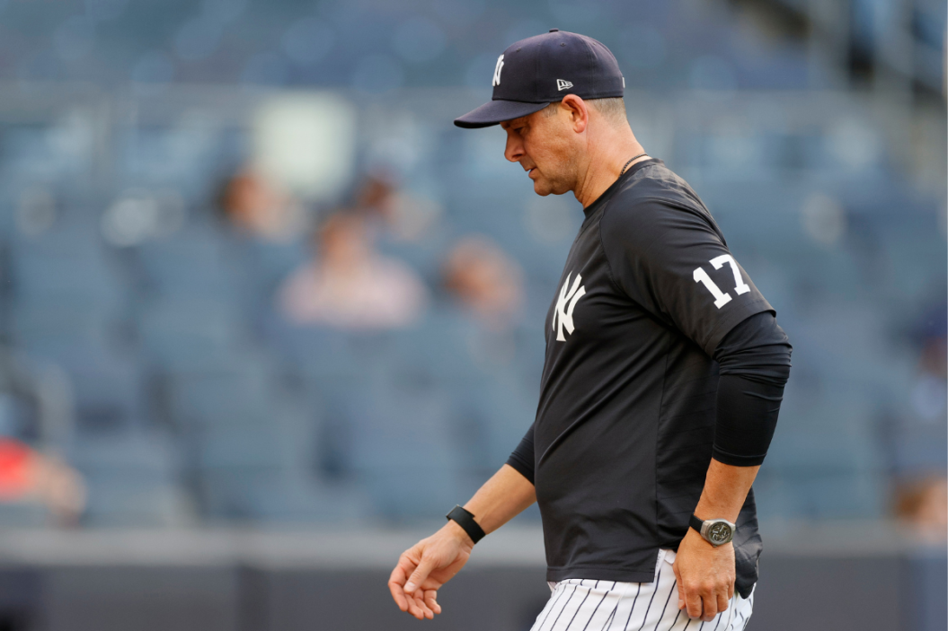 Manager Aaron Boone #17 of the New York Yankees walks to the dugout during the sixth inning of Game One of a doubleheader against the Toronto Blue Jays at Yankee Stadium