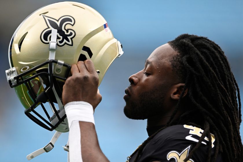 Alvin Kamara #41 of the New Orleans Saints puts on his helmet for warm ups before their game against the Carolina Panthers