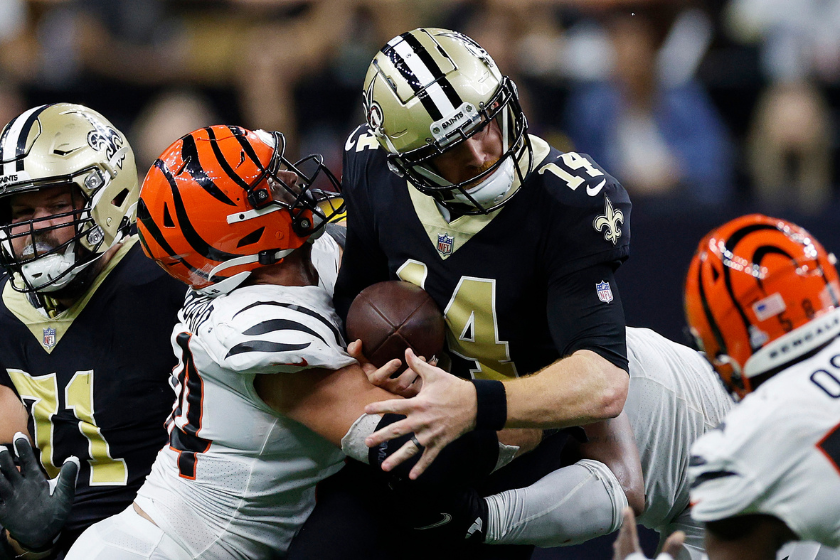 Andy Dalton #14 of the New Orleans Saints is sacked by Sam Hubbard #94 of the Cincinnati Bengals during the fourth quarter at Caesars Superdome 