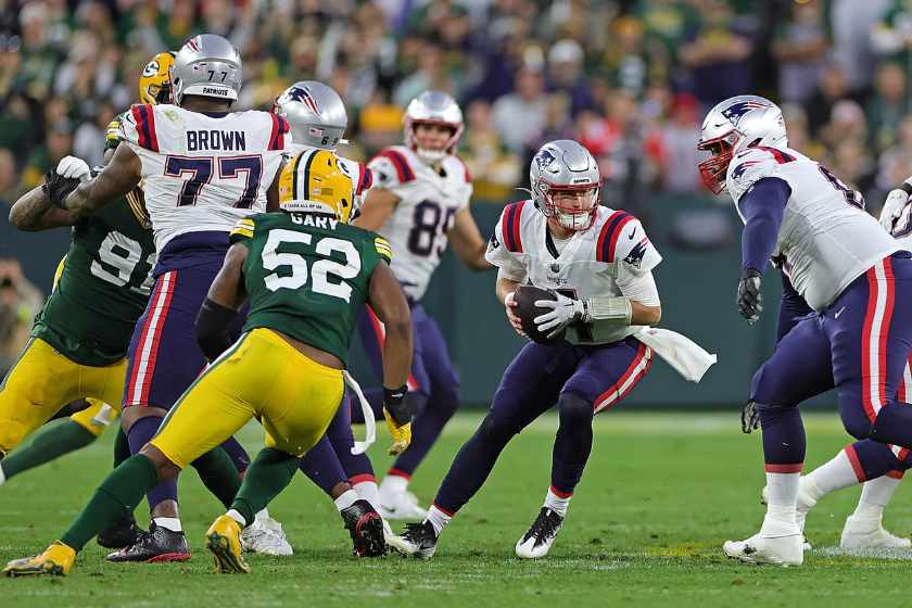 Bailey Zappe #4 of the New England Patriots looks to pass during a game against the Green Bay Packers