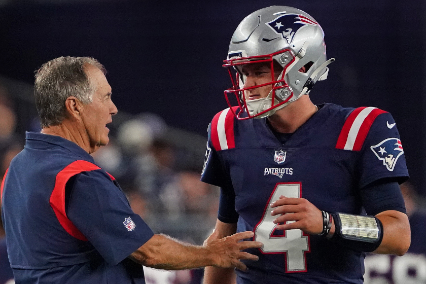 New England Patriots head coach Bill Belichick talks to quarterback Bailey Zappe