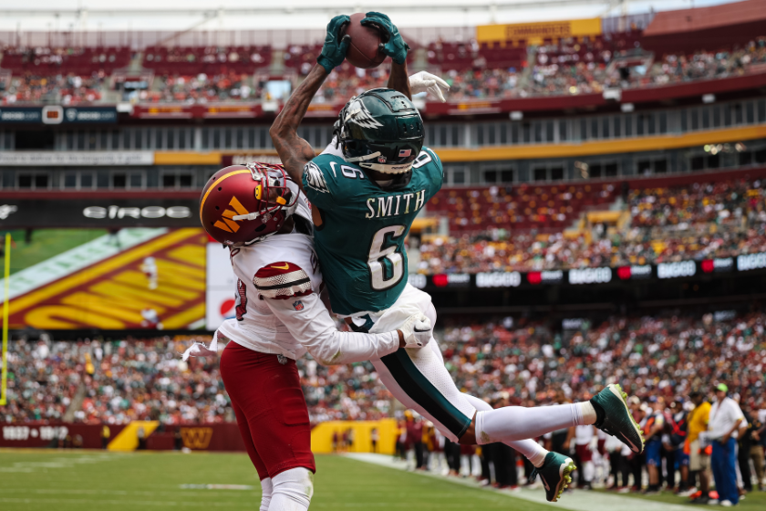 DeVonta Smith #6 of the Philadelphia Eagles makes a leaping catch for a touchdown against Kendall Fuller #29 of the Washington Commanders