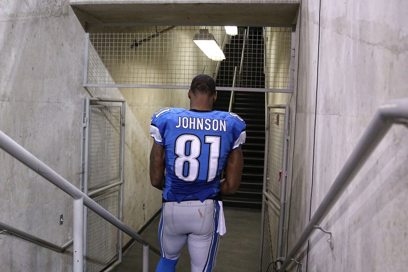 Calvin Johnson walks down the steps into the locker room at Ford Field.