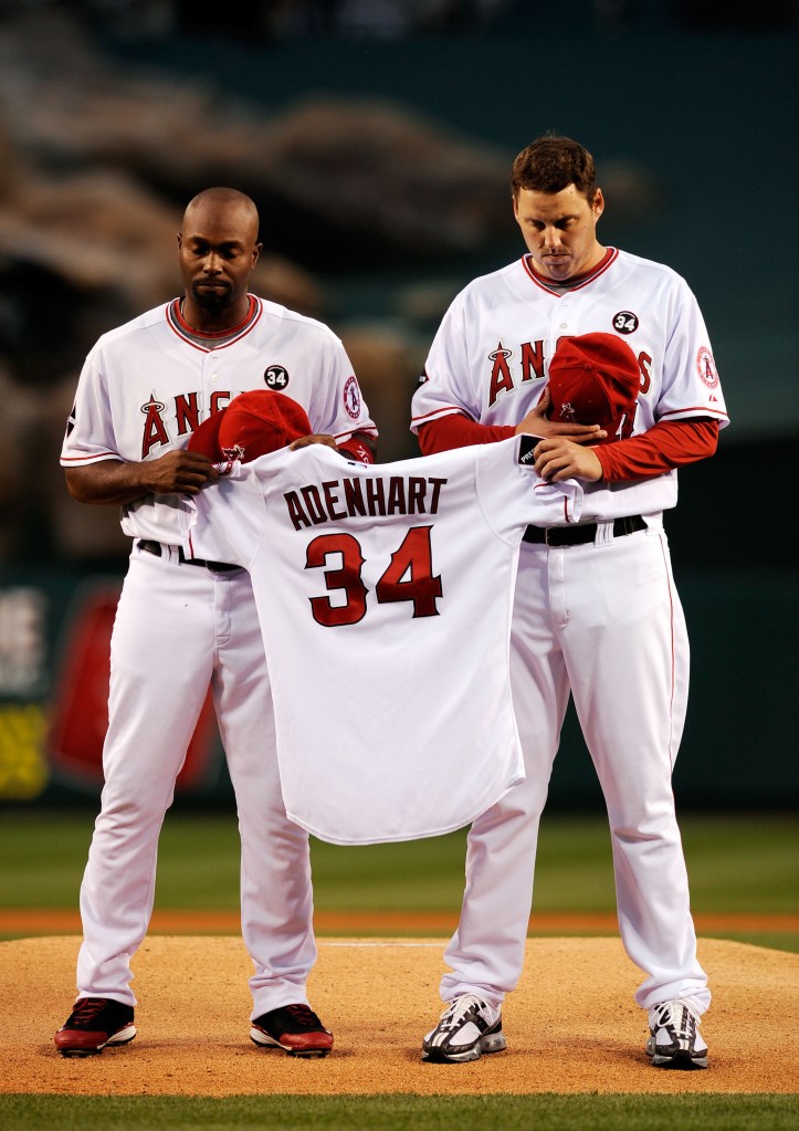 Nick Adenhart's teammates hold his jersey after his death.