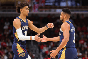 Jaxson Hayes #10 of the New Orleans Pelicans high fives CJ McCollum #3 against the Chicago Bulls during the first half of a preseason game at the United Center