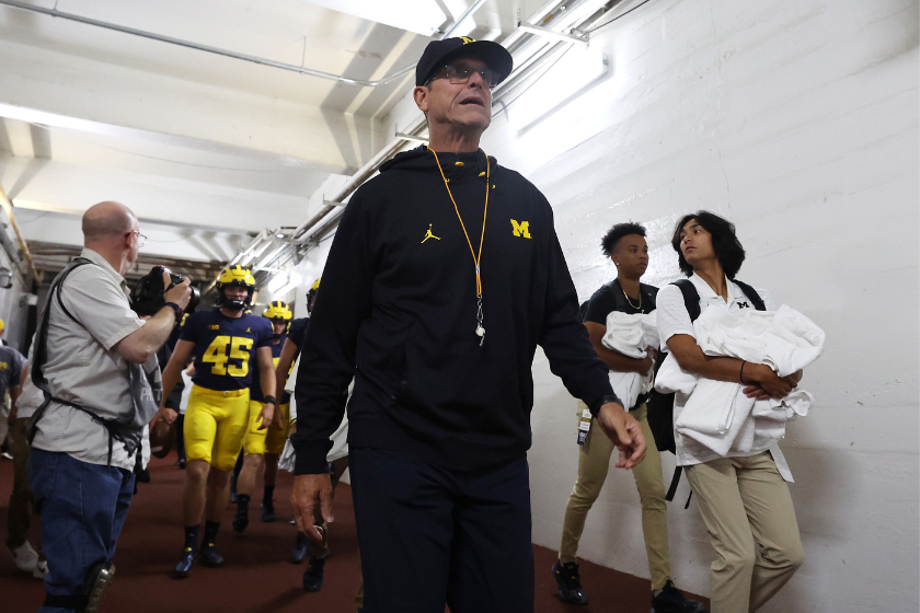 Head coach Jim Harbaugh walks down the tunnel prior to playing the Hawaii Warriors at Michigan Stadium
