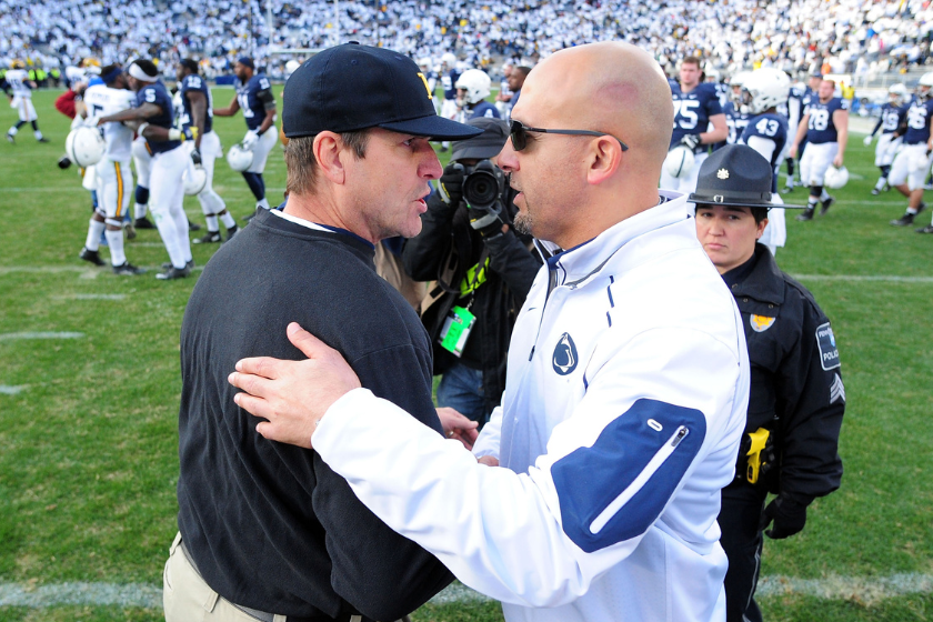 James Franklin head coach of the Penn State Nittany Lions congratulates Jim Harbaugh head coach of the Michigan Wolverines