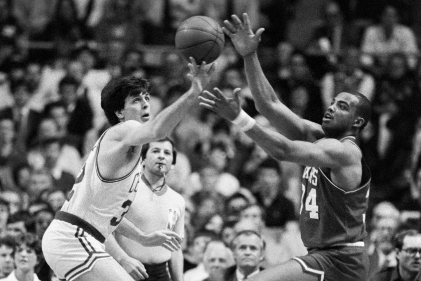 Boston Celtic Kevin McHale (left) challenges Philadelphia 76er Charles Barkley for a loose ball in an NBA basketball game 
