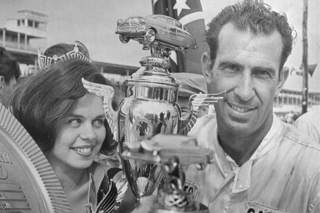 Ned Jarrett with 16th annual Southern 500 trophy next to Vicky Johnson, Miss 500