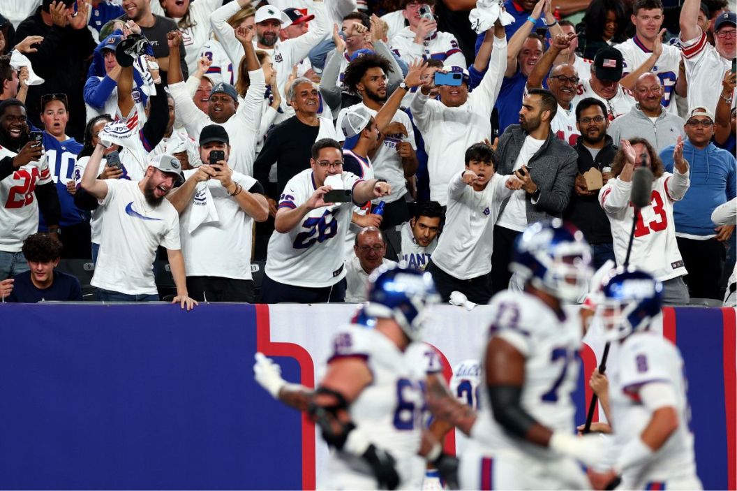 Fans celebrate after Saquon Barkley #26 of the New York Giants celebrates scored a 36 yard touchdown against the Dallas Cowboys