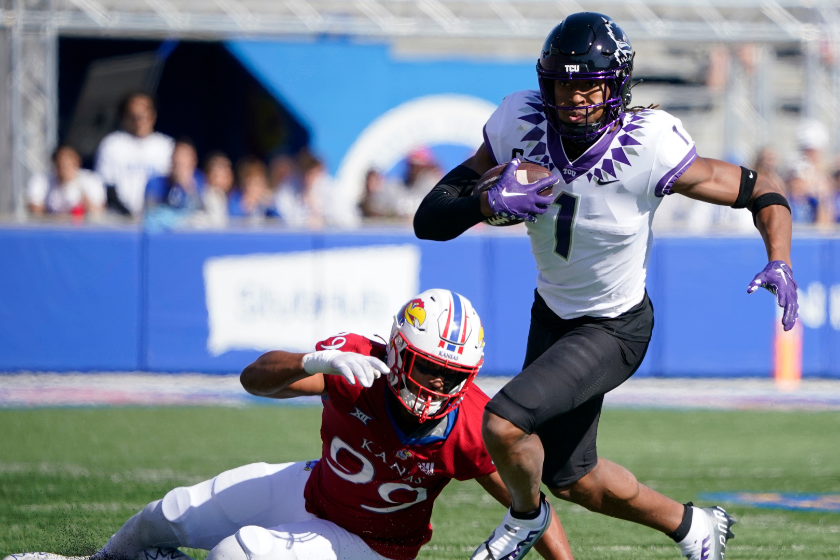 Wide receiver Quentin Johnston #1 of the TCU Horned Frogs gets past defensive lineman Malcolm Lee #99 of the Kansas Jayhawks