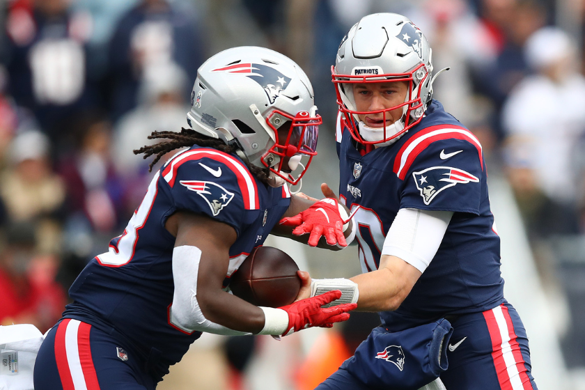 Mac Jones #10 of the New England Patriots hands the ball off to Rhamondre Stevenson #38 of the New England Patriots during the first half against the Atlanta Falcons