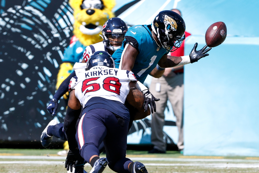  Linebacker Christian Kirksey #58 of the Houston Texans makes a tackle againt Runningback Travis Etienne #1 of the Jacksonville Jaguars which caused him to fumble