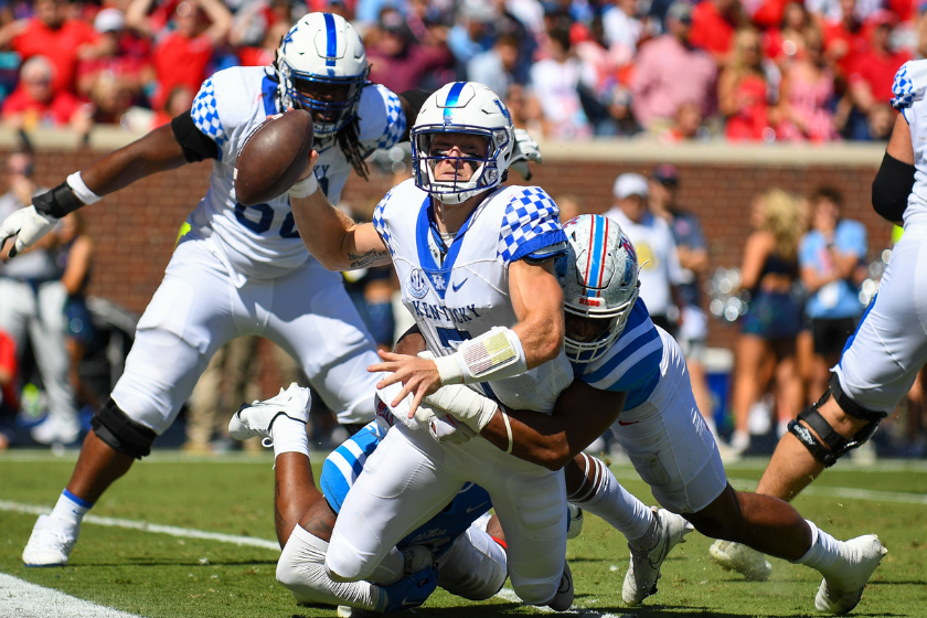Kentucky quarterback Will Levis (7) is brought down by Ole' Miss defensive end Tavius Robinson (95)