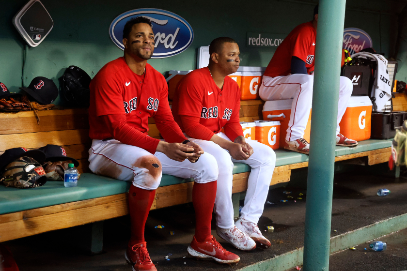 Rafael Devers #11 of the Boston Red Sox and Xander Bogaerts, left, in the dugout during the fourth inning of the game against the Tampa Bay Rays