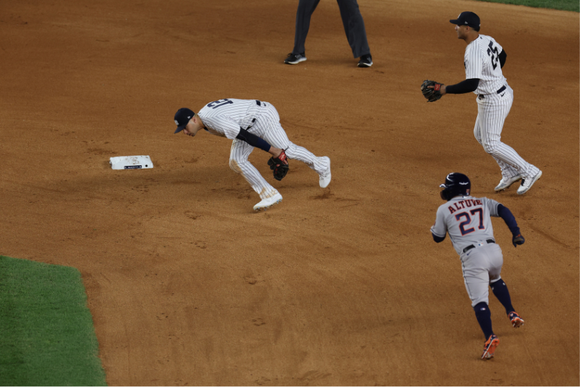 siah Kiner-Falefa #12 of the New York Yankees is unable to field a ball hit by Jeremy Pena #3 of the Houston Astros during the seventh inning in game four of the American League Championship Series