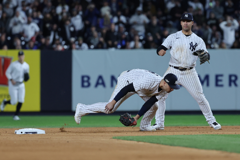New York Yankees shortstop Isiah Kiner-Falefa cannot handle the throw from New York Yankees second baseman Gleyber Torres in the 7th inning in game 4 of the ALCS against the Houston Astros