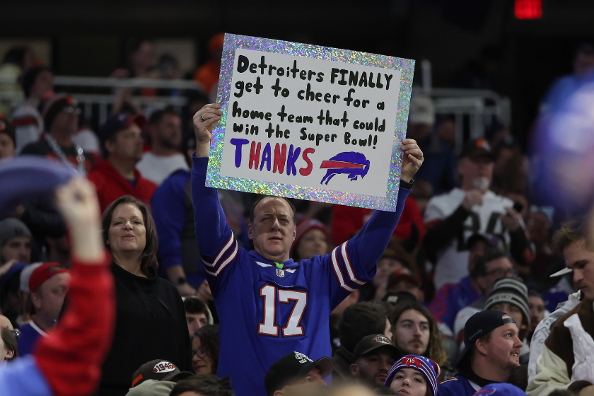 A Buffalo Bills fan holds a sign against the Cleveland Browns at Ford Field