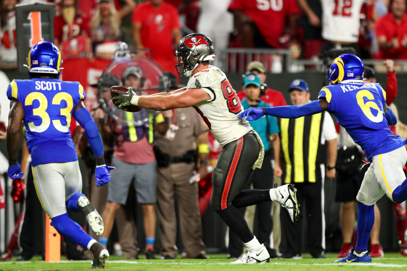 Cade Otton #88 of the Tampa Bay Buccaneers carries the ball over the goal line to score a touchdown during the fourth quarter of an NFL football game against the Los Angeles Rams at Raymond James Stadium