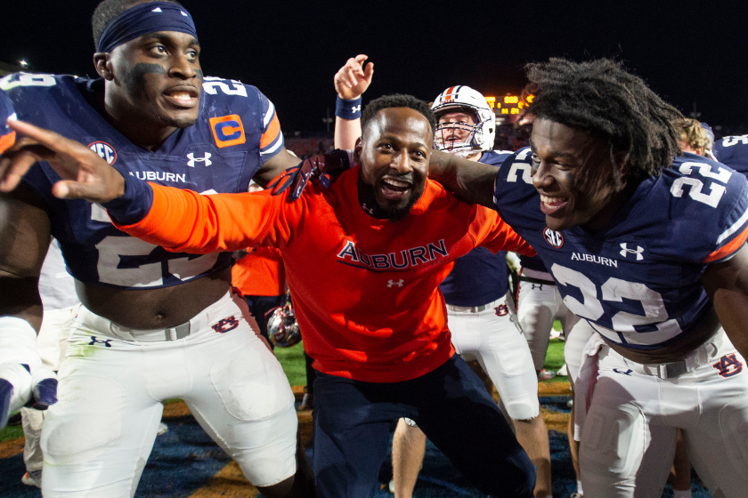 Interim head coach Carnell Williams of the Auburn Tigers celebrates with linebacker Derick Hall #29 of the Auburn Tigers and running back Damari Alston #22 of the Auburn Tigers after defeating the Western Kentucky Hilltoppers
