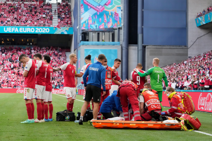 Christian Eriksen (Hidden) of Denmark receives medical treatment during the UEFA Euro 2020 Championship Group B match between Denmark and Finland