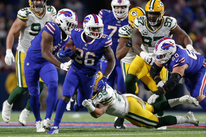 Devin Singletary #26 of the Buffalo Bills is tackled by Isaiah McDuffie #58 of the Green Bay Packers during the fourth quarter at Highmark Stadium