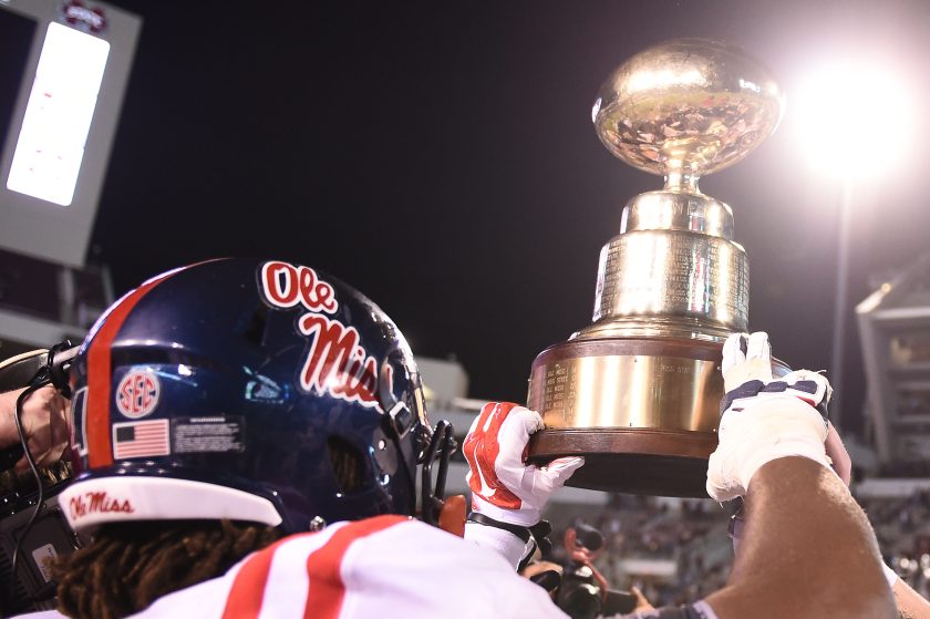 Ole Miss players hold up the Golden Egg Trophy.