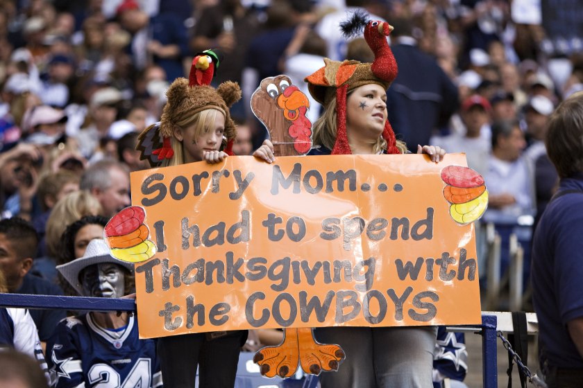 Cowboys fans hold up a sign during a Thanksgiving game.