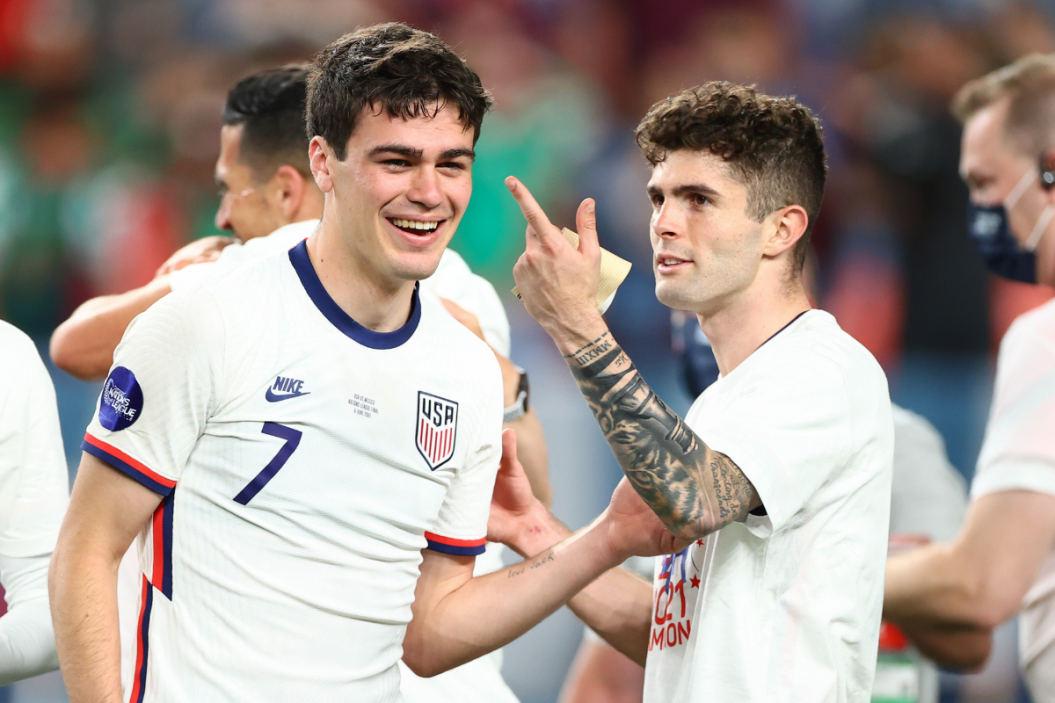 Christian Pulisic #10 and Giovanni Reyna #7 of the United States celebrate their win over Mexico in the Nations League Final during a game between Mexico and USMNT