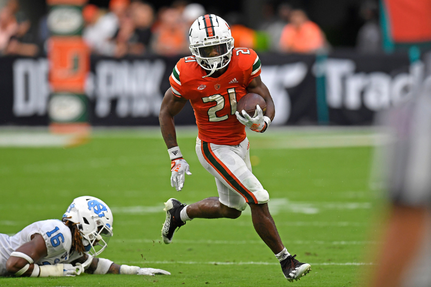Miami running back Henry Parrish, Jr. (21) evades North Carolina defensive back Deandre Boykins (16) while carrying the ball in the third quarter