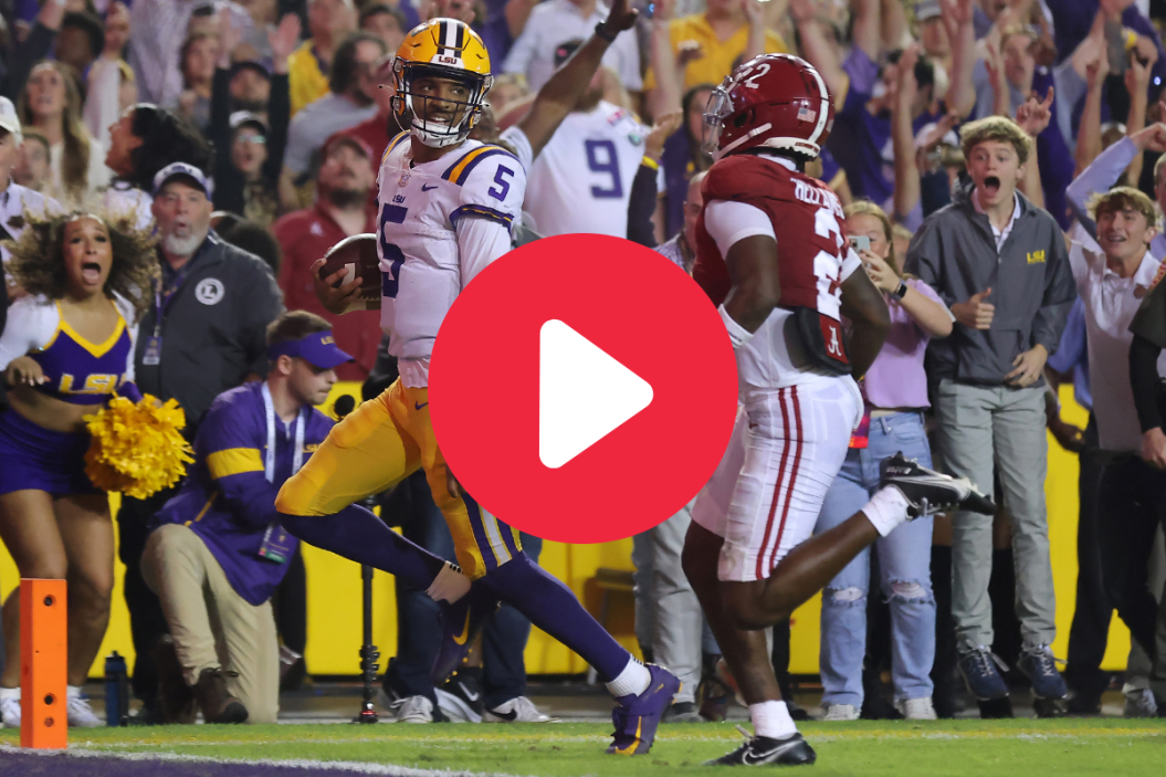 Jayden Daniels #5 of the LSU Tigers rushes for a touchdown as DeMarcco Hellams #2 of the Alabama Crimson Tide defends during overtime at Tiger Stadium