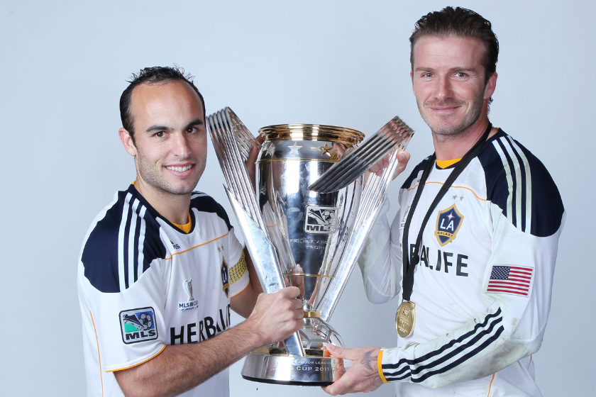 Landon Donovan #10 and David Beckham #23 of the Los Angeles Galaxy pose for a portrait following the 2011 MLS Cup